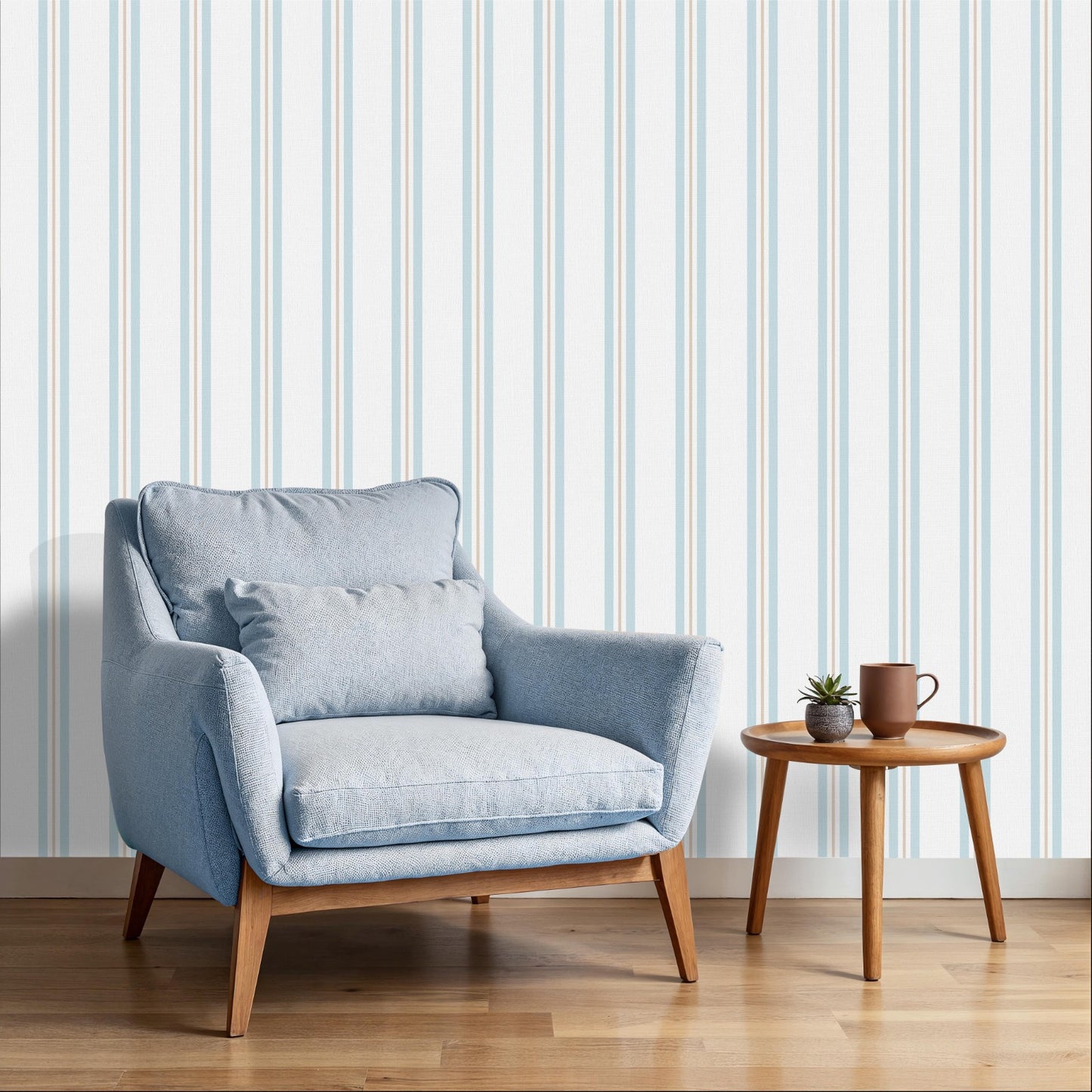 A bright sitting area features a clean coastal dune blue and white striped wallpaper.
The detailed design shows thin blue and beige vertical stripes repeating down a light base.
In front, a plush light blue armchair with a matching lumbar pillow rests comfortably.
The relaxing space is complete with a small wooden side table holding a mug and plant.