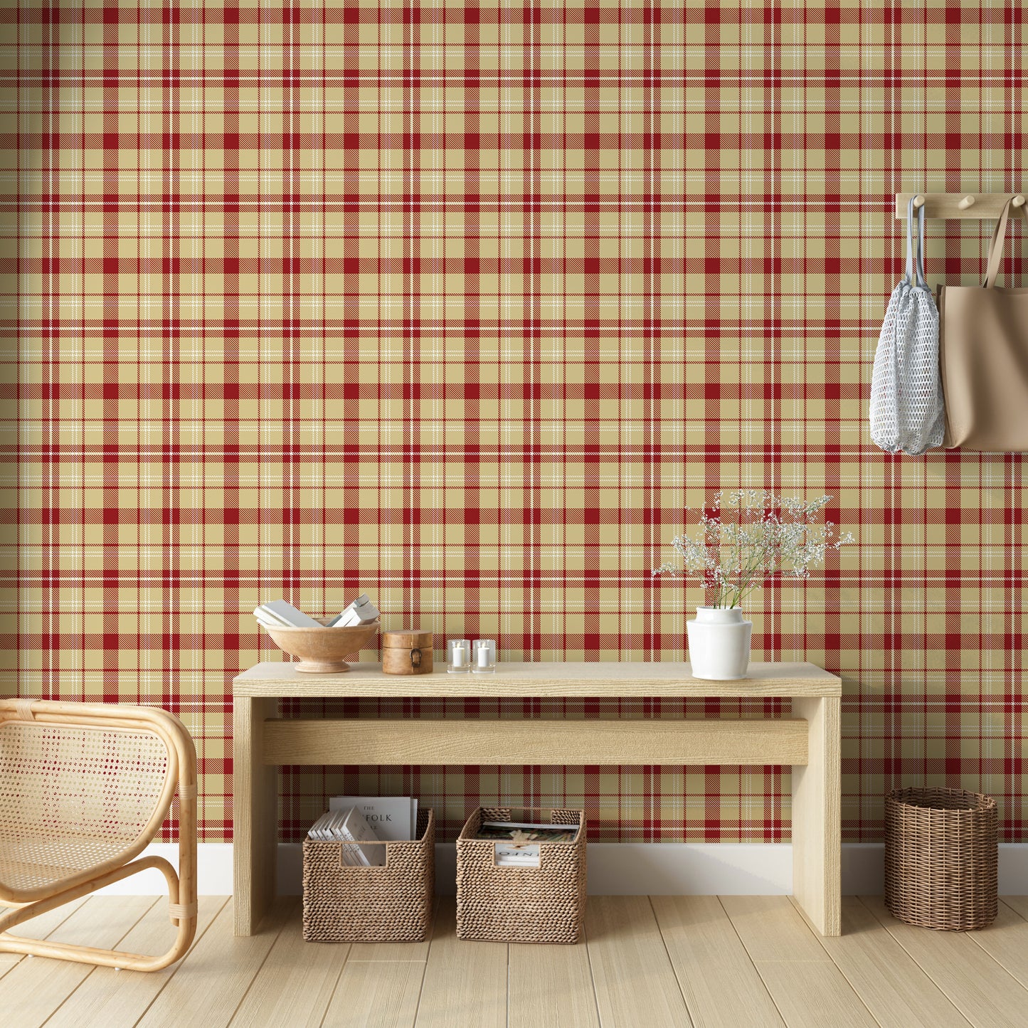 A cozy interior featuring red and beige plaid wallpaper with a woven fabric appearance. The room includes a light wood console table with small decorative items and flowers, woven storage baskets underneath, a wicker chair, and hanging tote bags on the wall.