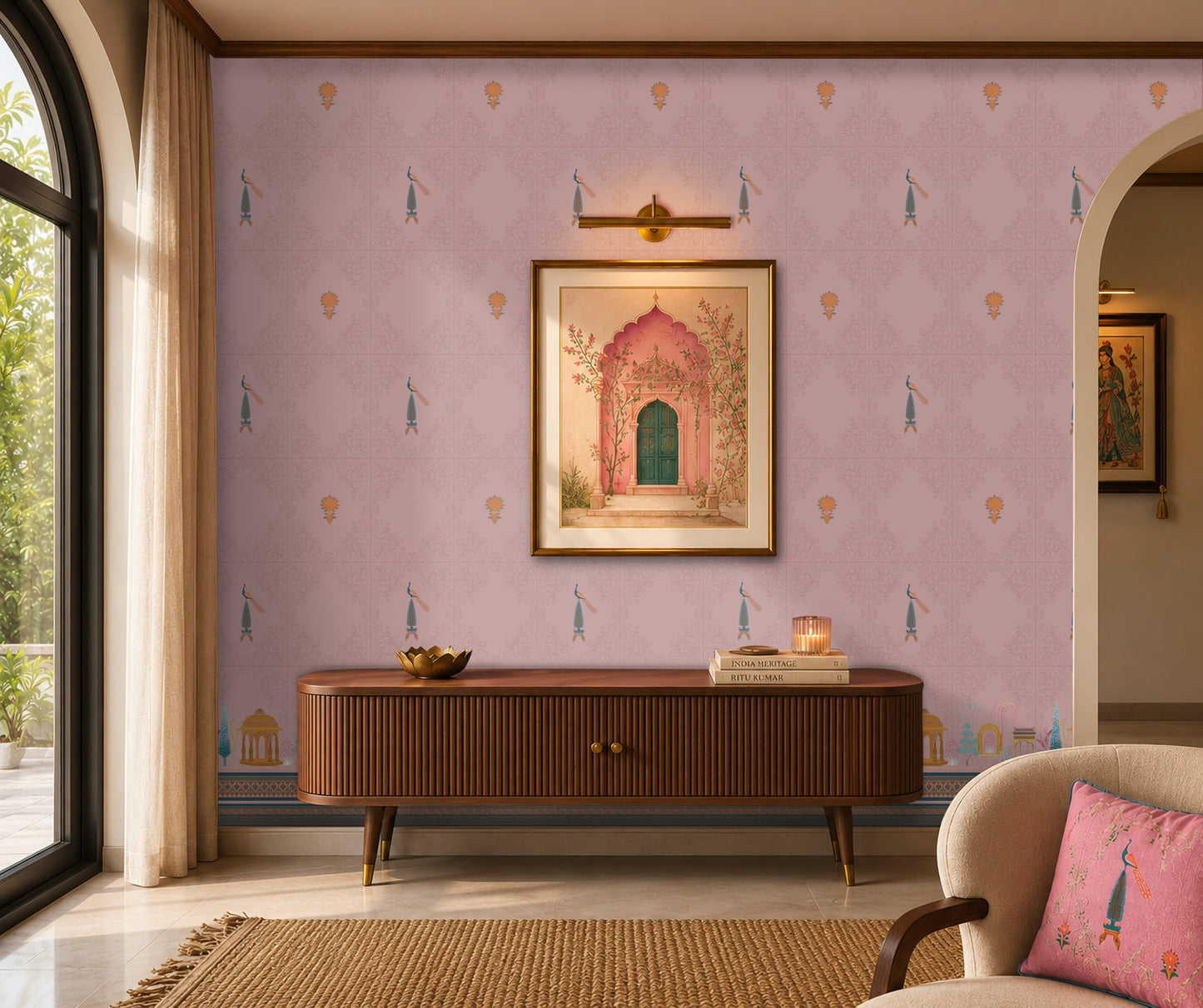 Elegant living room featuring soft pink Mughal-inspired wallpaper with delicate floral motifs, peacock accents, and heritage architectural border designs. Styled with a mid-century wooden console, framed artwork, warm lighting, and contemporary décor for a refined Indian-inspired interior.