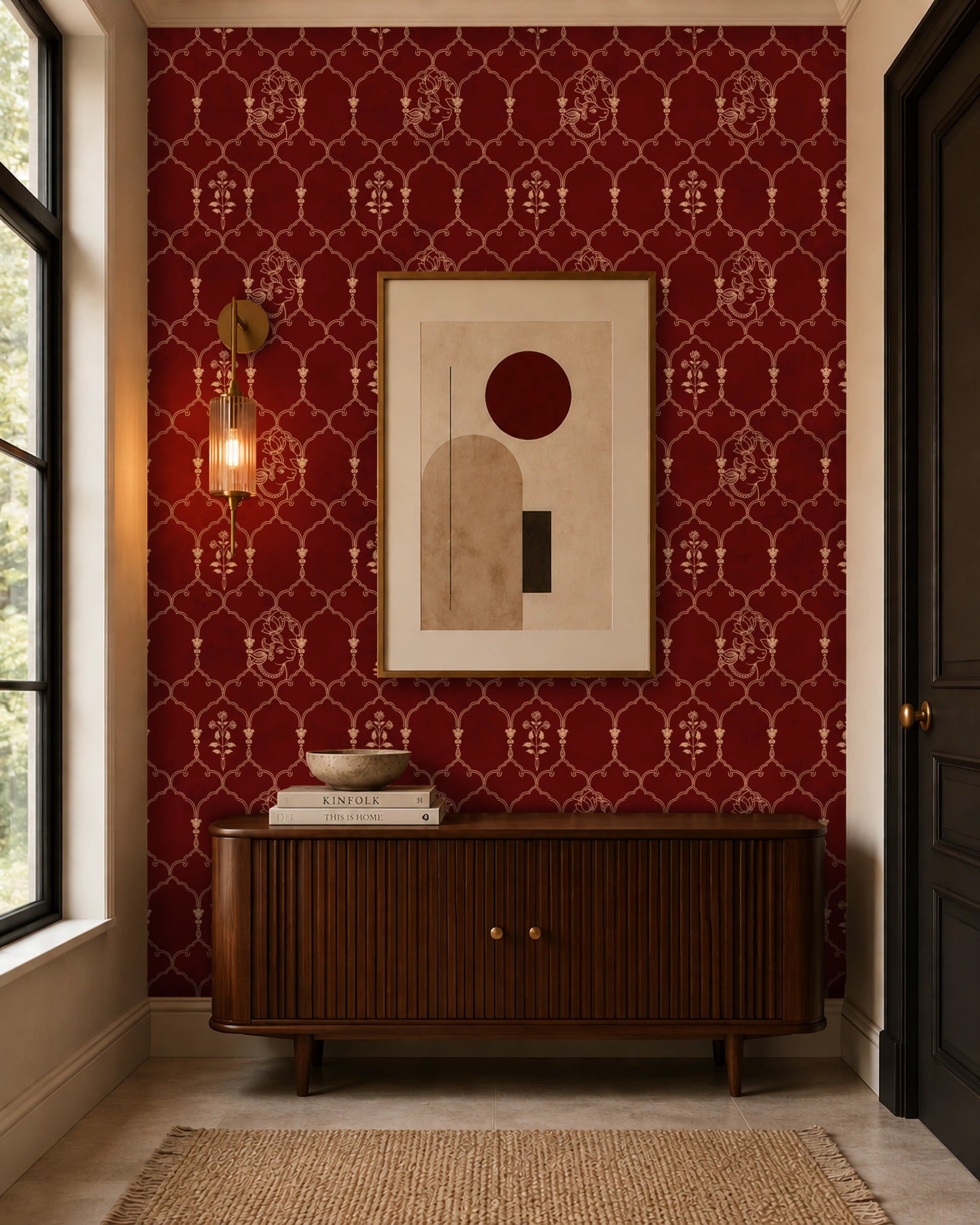 Modern entryway featuring rich burgundy wallpaper with an elegant Mughal-inspired trellis pattern, styled with a mid-century wooden console, abstract framed artwork, brass wall sconce, and warm contemporary décor for a sophisticated luxury interior.