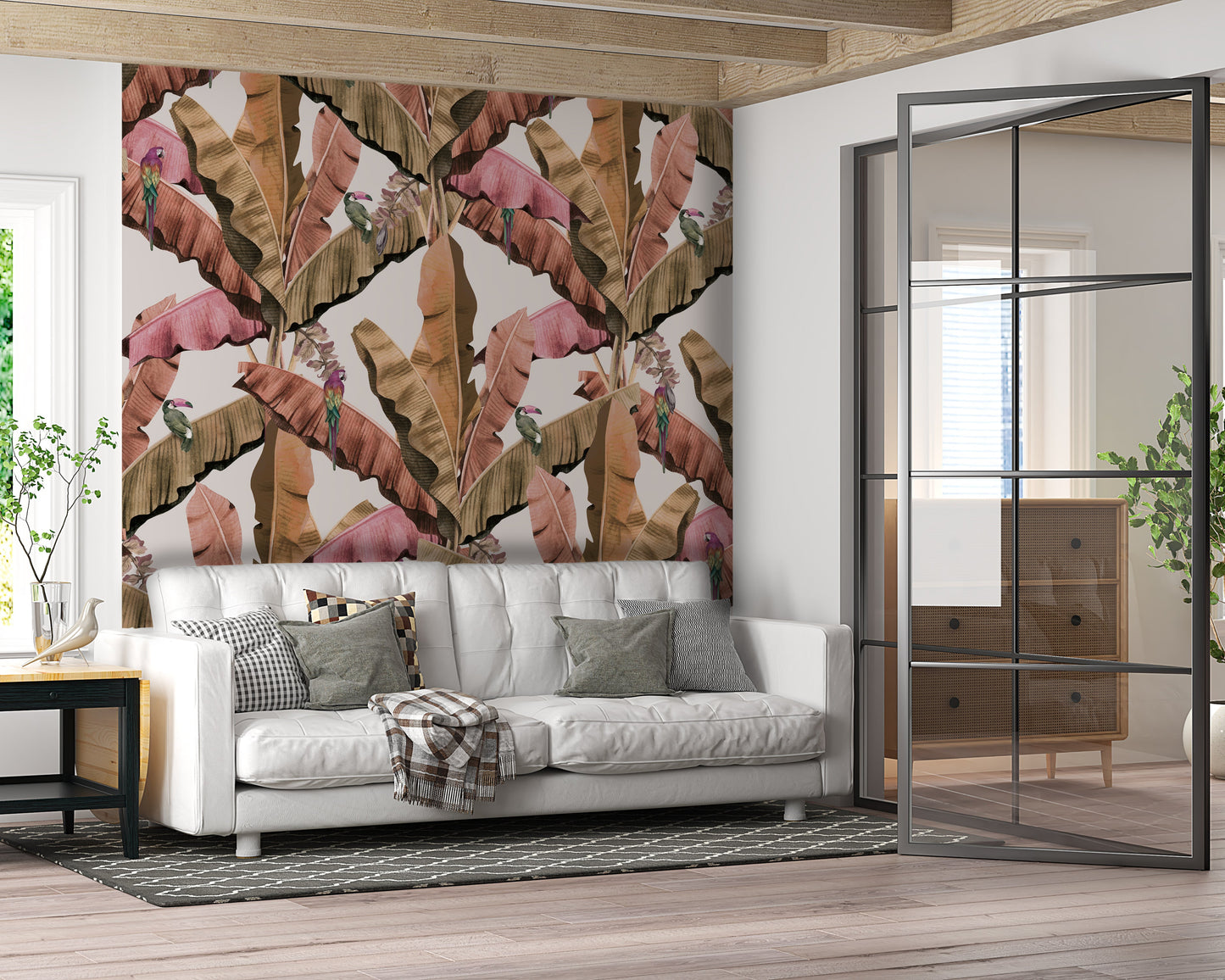 An architectural perspective of a contemporary living room featuring the Banana Leaves Pattern as a full-scale accent wall. The wallpaper’s soft green and ivory tones pair strikes an elegant balance with cream-colored upholstery, light oak furniture, and minimalist decor, creating a high-energy yet serene tropical atmosphere.
