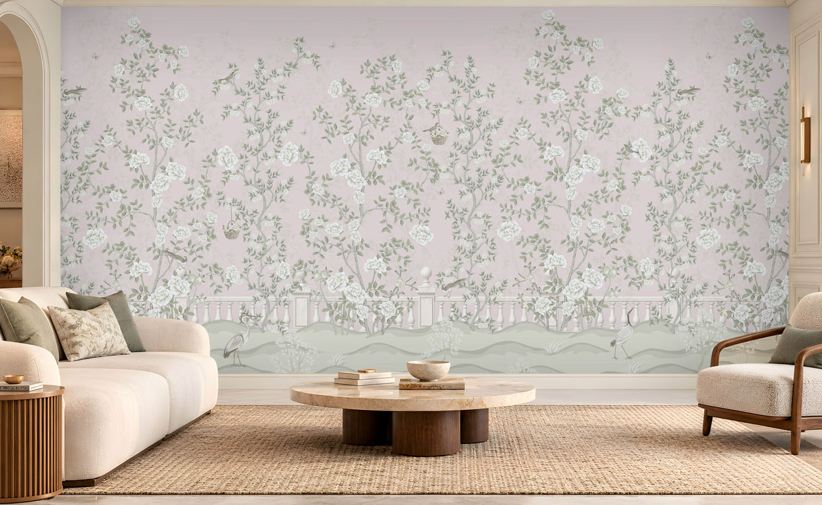 Elegant living room featuring Florentine Bloom blush pink floral wallpaper with white roses and botanical vines, complemented by a cream sofa, natural wooden furniture, and soft daylight.