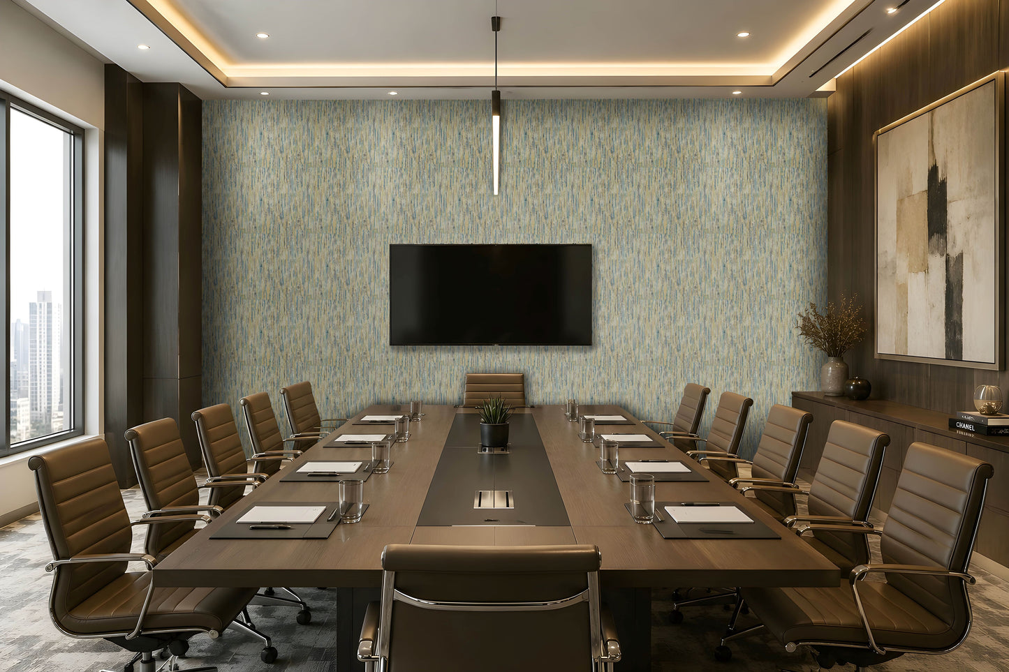 A modern conference room with a long rectangular wooden table, multiple brown office chairs, a large wall-mounted TV, patterned blue-gray wallpaper, recessed ceiling lighting, and a large framed abstract artwork on the right wall.