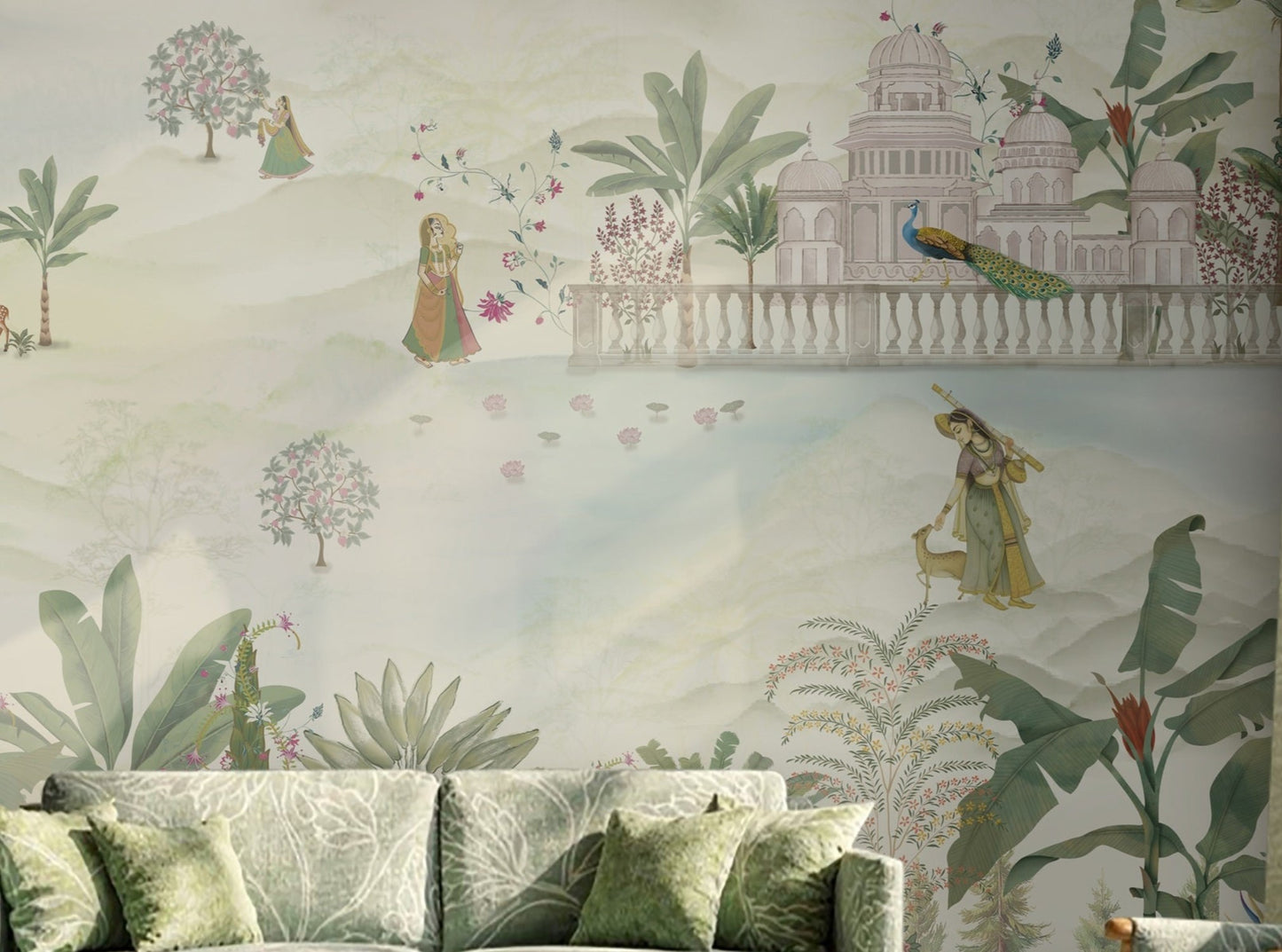 Royal Vrindavan Pichwai wallpaper mural in soft pastel sage green, beige and blush pink tones featuring Indian palace gardens, trees, peacocks and scenic landscape design in a luxury living room setting.