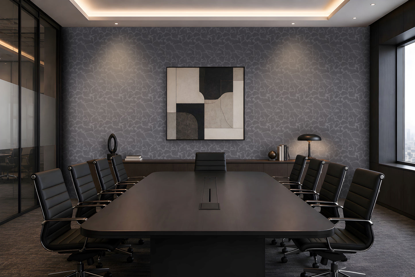 A modern conference room with a long dark wood table, black office chairs, a patterned gray wall, and a framed abstract geometric painting in the center.
