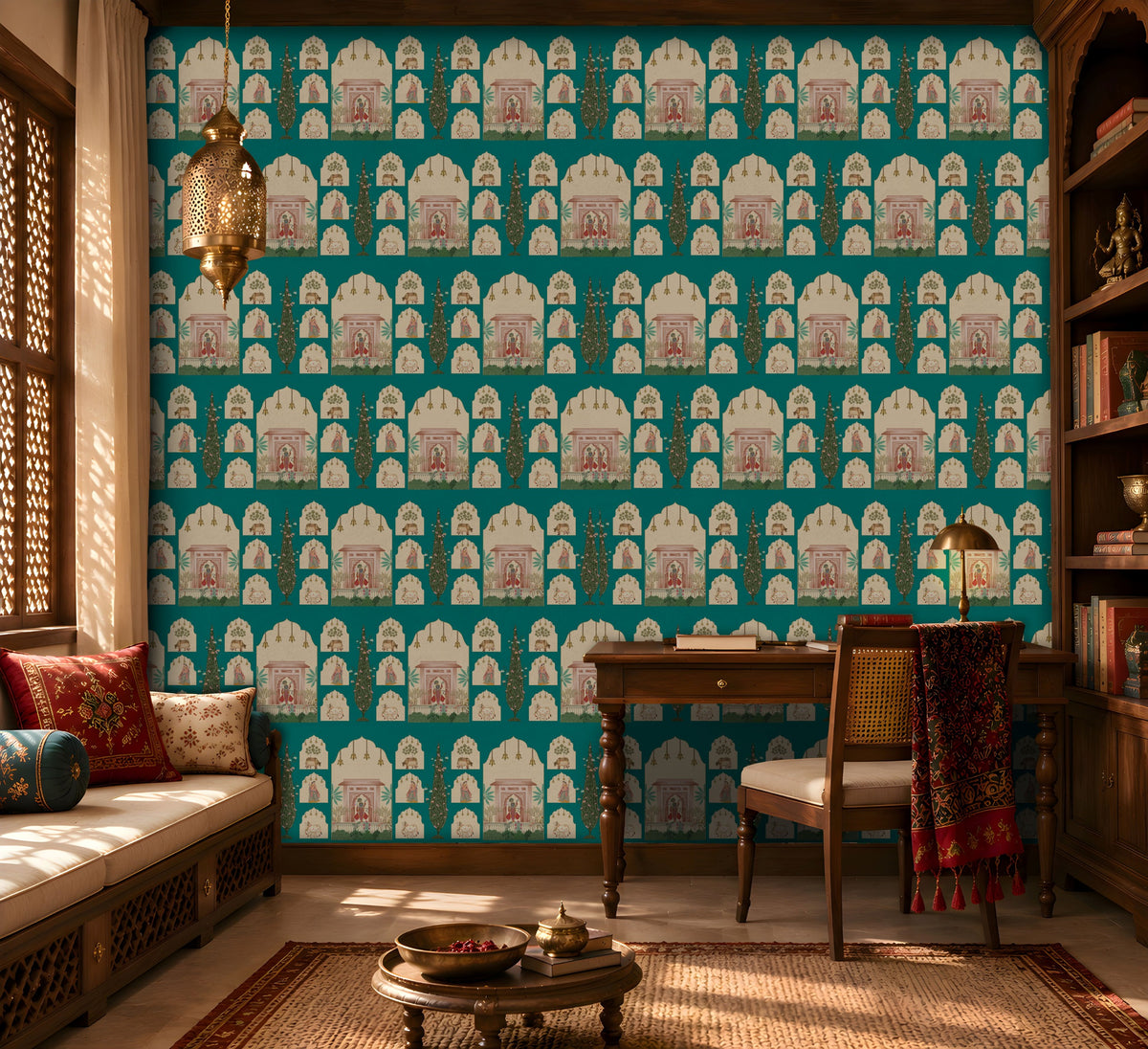 Shriji Darbar Heritage Wallpaper in Aqua blue featuring traditional Indian palace arches, royal darbar illustrations, ornamental motifs, and elegant cypress trees in a seamless repeating pattern, showcased in a refined study room with carved wooden furniture, brass lighting, bookshelves, and warm natural sunlight.