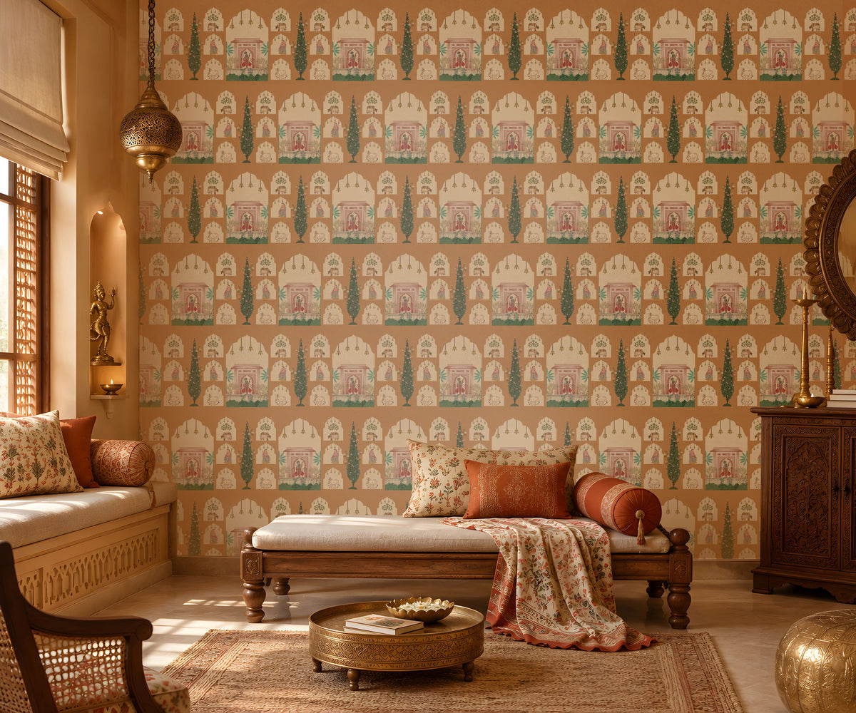 Shriji Darbar Heritage Wallpaper featuring intricate Indian palace arches, royal court illustrations, and elegant cypress tree motifs on a warm terracotta beige background, displayed in a luxurious traditional living room with carved wooden furniture, ethnic textiles, and brass décor accents.