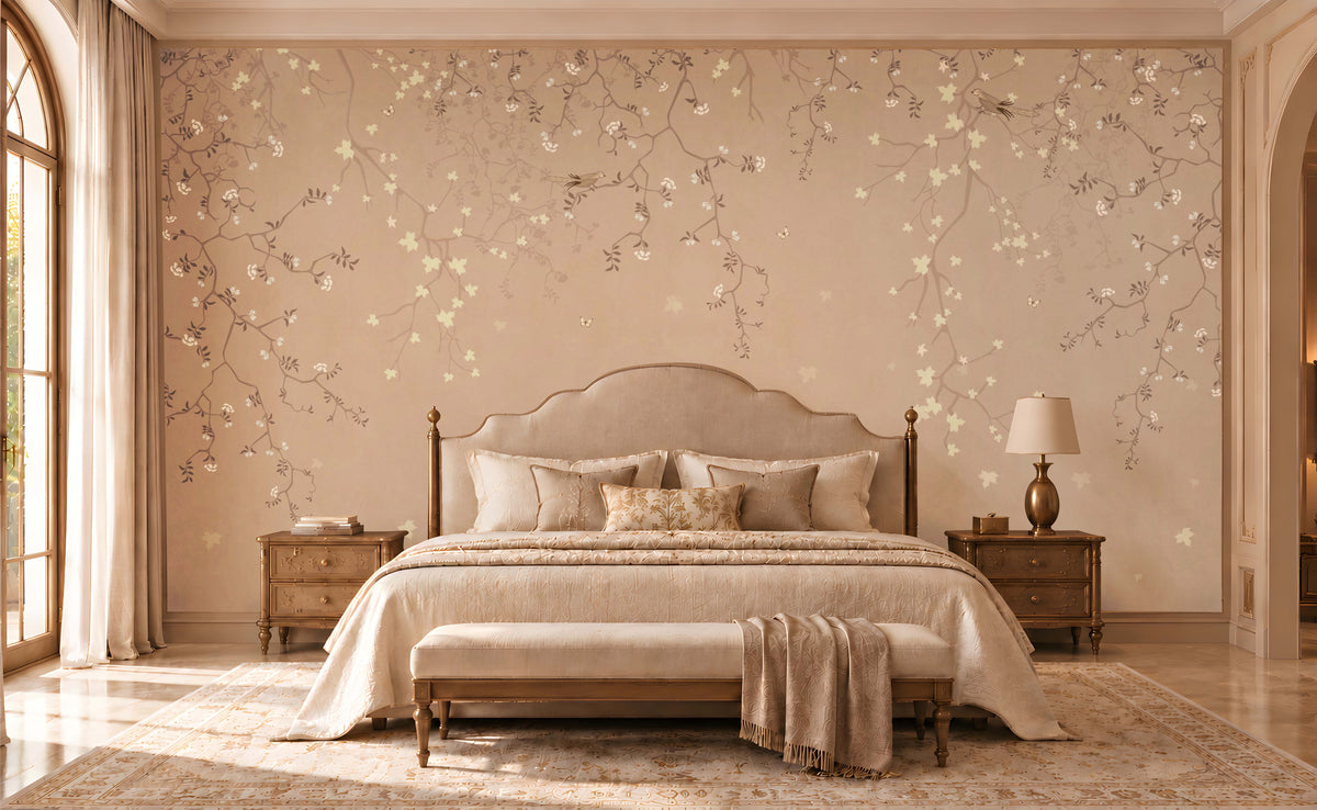 Elegant bedroom featuring Silent Breeze Warm Blush Beige Botanical Birds Wallpaper with delicate branches, subtle floral motifs, cream upholstered bed, wooden bedside tables, and soft natural lighting.