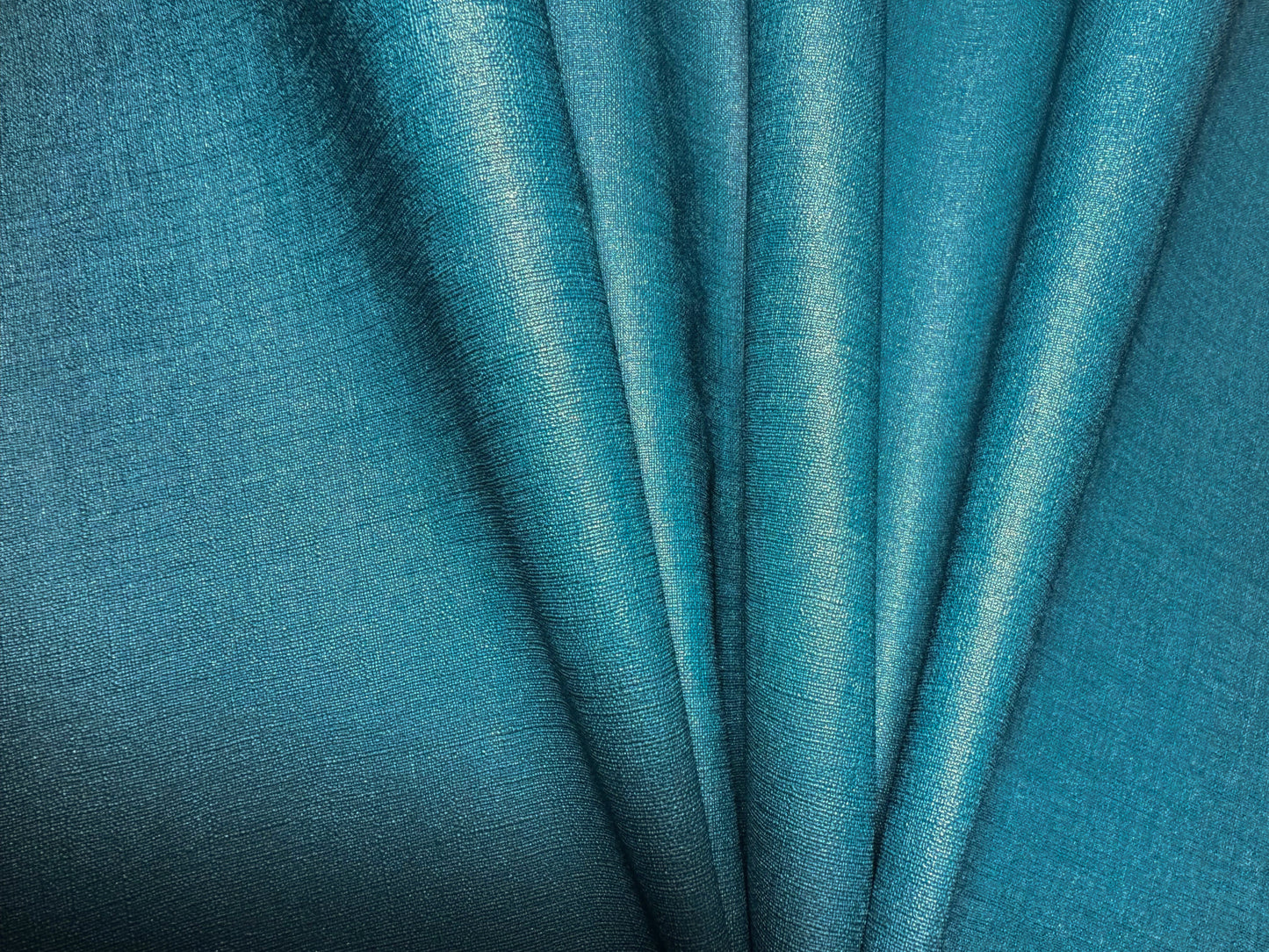 Close-up view of Waterproof Fabric Backed Commercial Wallcovering in Forest Teal, showcasing a heavy-duty, industrial textile texture with a luminous metallic sheen and deep teal accents on a durable vinyl surface.