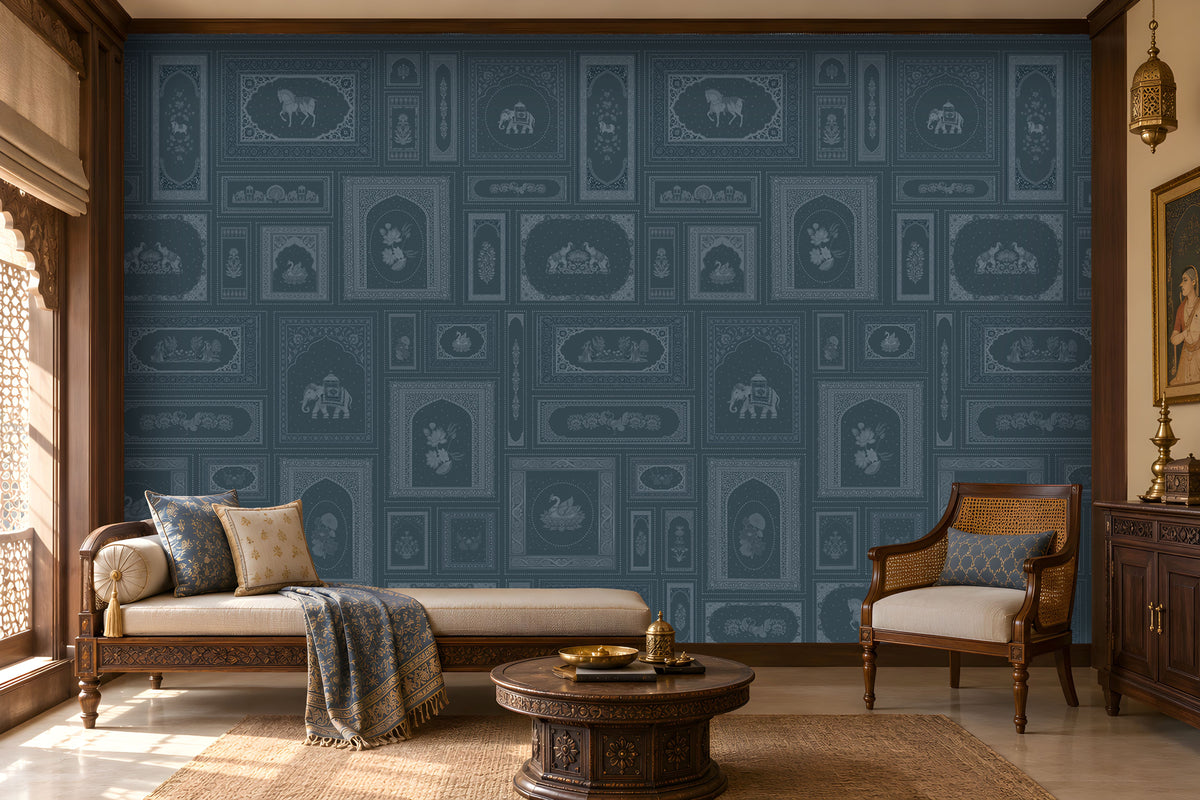 The Royal Rajputana Courtyard wallpaper in Antique Teal Blue featuring intricate Rajasthani palace-inspired motifs, elephant illustrations, floral panels, Mughal arches, and heritage detailing in an elegant traditional living room.