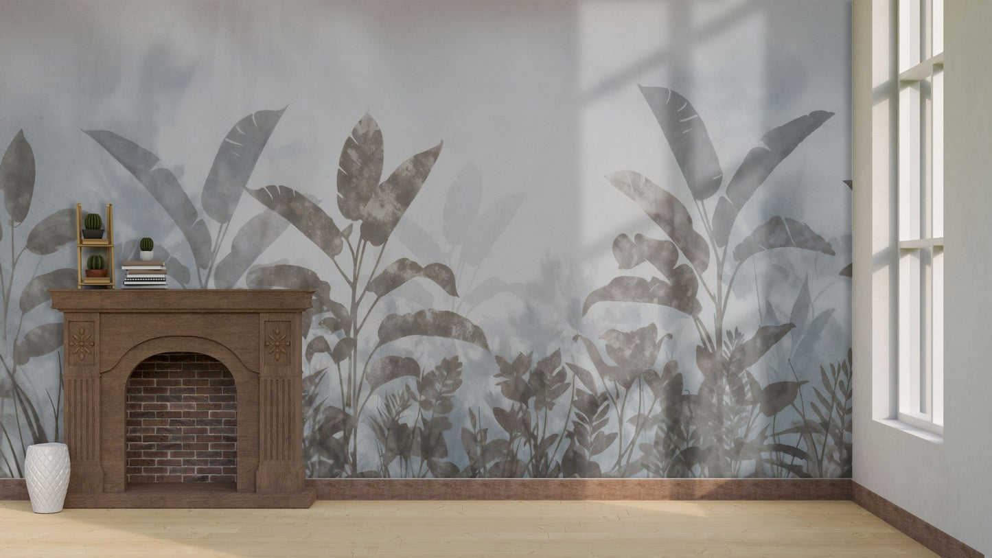 An architectural perspective of a refined room featuring the Silver Mist Tropical Leaf Mural as a full-scale feature wall behind a classic wooden fireplace mantel. The mural’s atmospheric depth and cool tones create a modern, immersive backdrop that pairs beautifully with natural wood flooring and light-filled spaces.