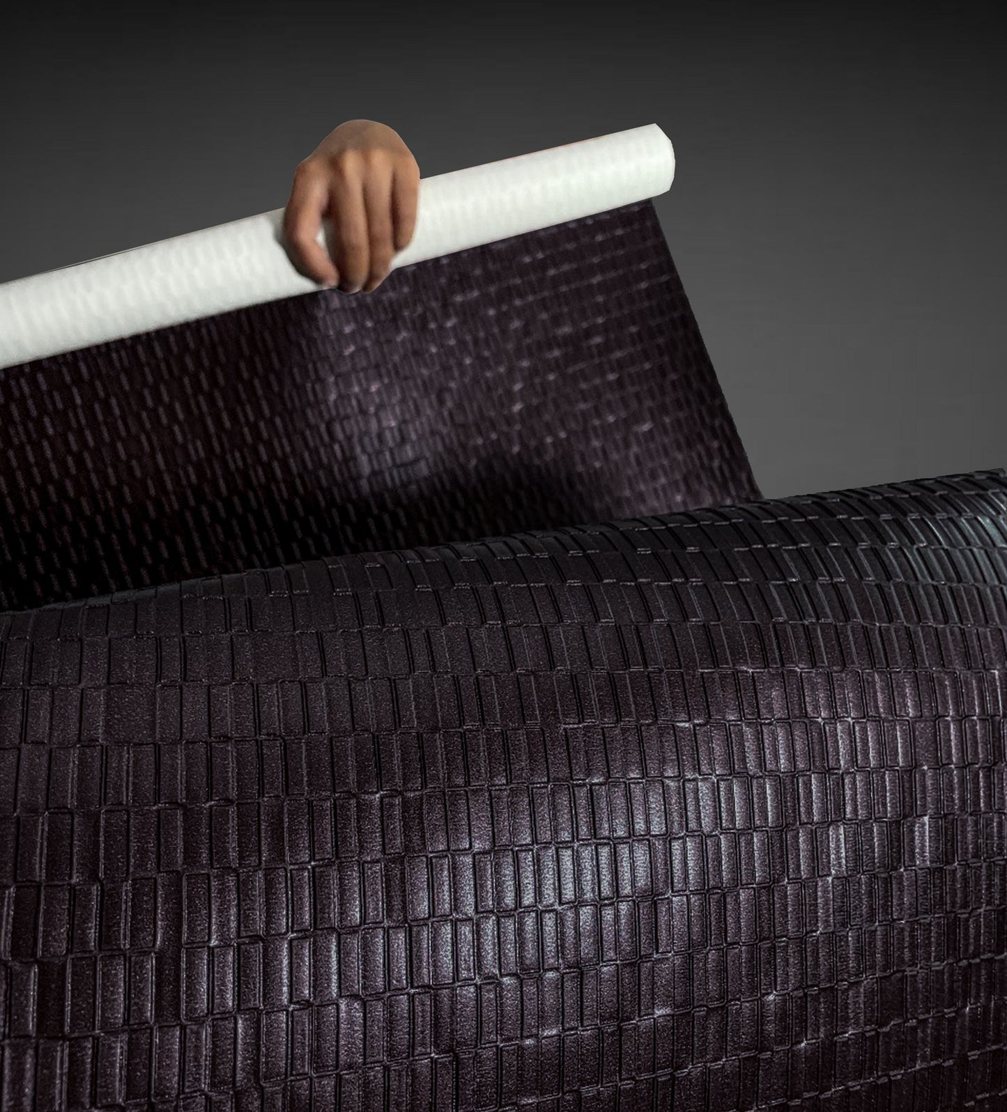 A high-resolution macro detail of Deep Purple Deep Texture Wallcovering, showcasing a high-relief rectangular grid pattern. The image captures the precisely embossed, raised blocks and the subtle, fine-grained texture of the deep purple surface, highlighting its architectural depth and light-reflective qualities.