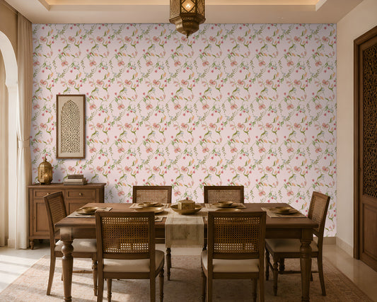 A dining room interior featuring a light pink floral wallpaper as the main wall backdrop, with a wooden dining table and woven-back chairs placed in front of it. A hanging lantern, sideboard, and decorative wall art are also visible.