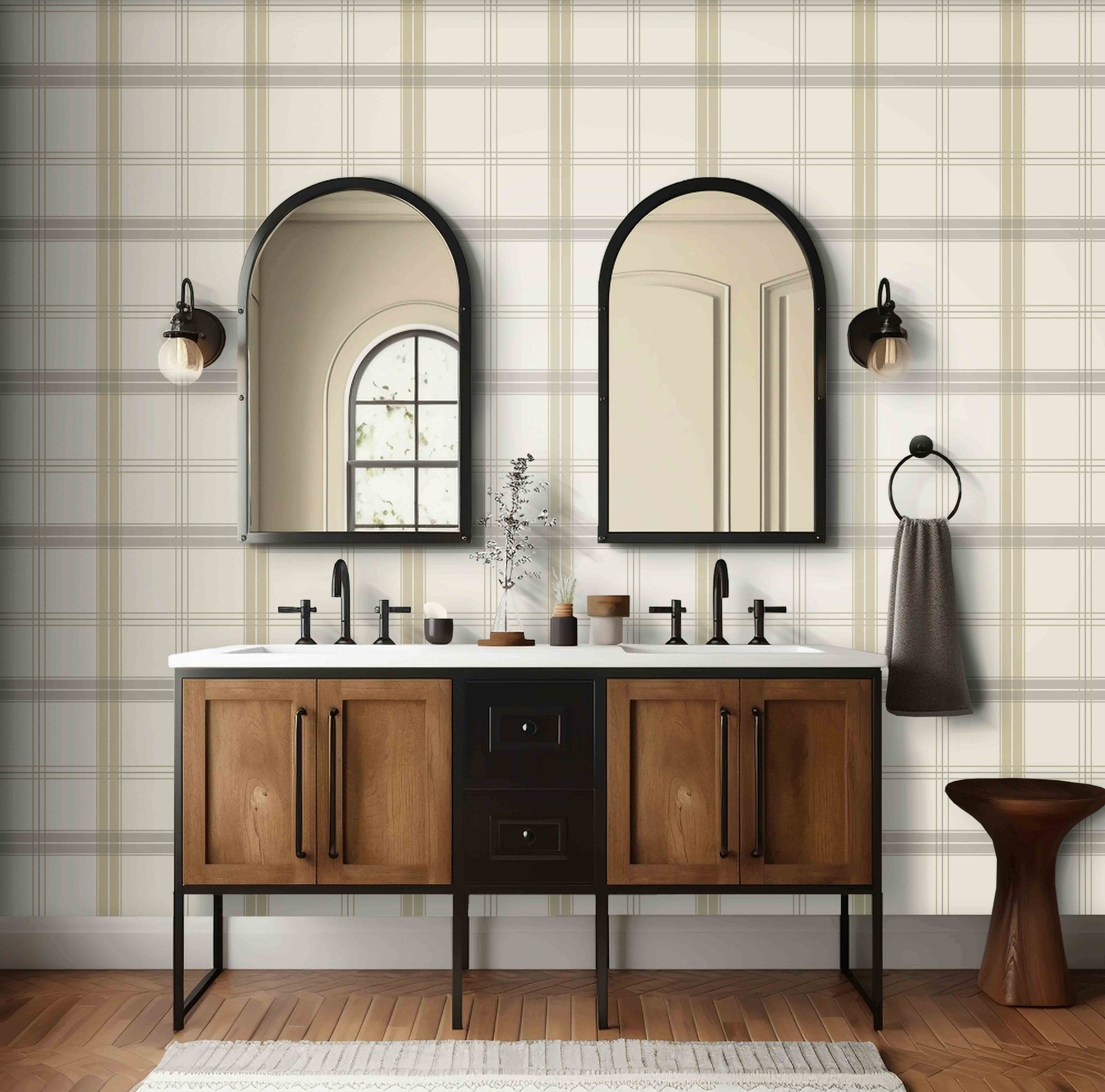 A neutral interior space features a classic plaid wallpaper in ivory and taupe tones.
The textured design displays a detailed grid pattern with intersecting beige, brown, and cream lines.
In front, a minimalist light-colored wooden wishbone chair with a woven seat is centered.
The simple setting is subtly completed by a small round side table holding a dark grey vase.