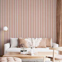 A bright and inviting living space features a warm peach and cream striped wallpaper.
The detailed design shows clean vertical peach bands alongside cream stripes with thin dotted lines.
In front, a plush white sofa is adorned with matching warm tan accent pillows.
The cozy room setup is beautifully completed with a light wood coffee table and a gold floor lamp.