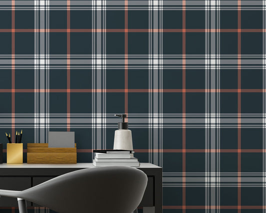 A sleek home office features a dark midnight blue and white plaid wallpaper.
The detailed design shows intersecting white and orange lines forming grids over a dark base.
In front, a simple black desk setup holds a modern table lamp and stationery.
The organized workspace is cleanly finished with a matching black office chair.