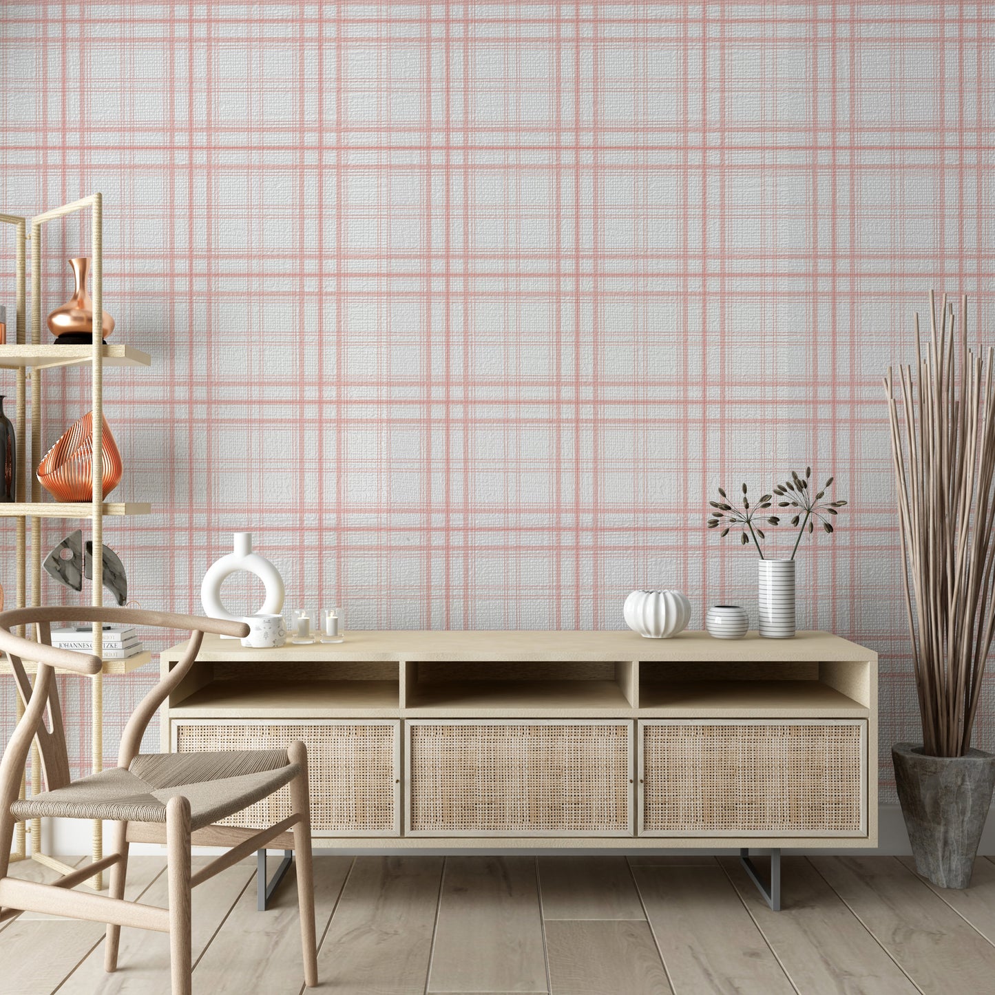 A calm living area features a textured, soft rosy haze pink and white plaid wallpaper.
The detailed design shows thin coral-pink lines intersecting to form clean grids across a light base.
In front, a light wood media console with woven rattan doors is centered nicely.
The relaxing space is accented with a wooden armchair, decorative pottery, and dried botanical stalks.