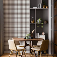 A cozy dining area features a classic warm brown and cream plaid wallpaper.
The detailed design shows intersecting brown stripes forming grids on a light base.
In front, a round wooden dining table is surrounded by four matching chairs.
A tall, dark grey open bookshelf stands on the right side to complete the space.