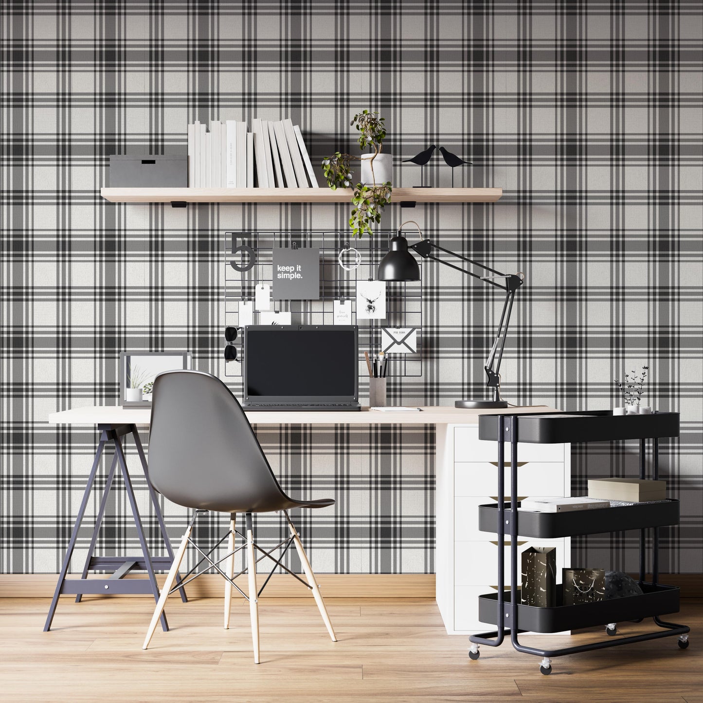 A modern home office features a classic charcoal grey and off-white plaid wallpaper.
The detailed pattern shows intersecting dark lines creating a clean grid on a light base.
In front, a sleek white study desk setup holds a laptop, lamp, and floating bookshelf.
The organized workspace is complete with a black office chair and a rolling utility cart.