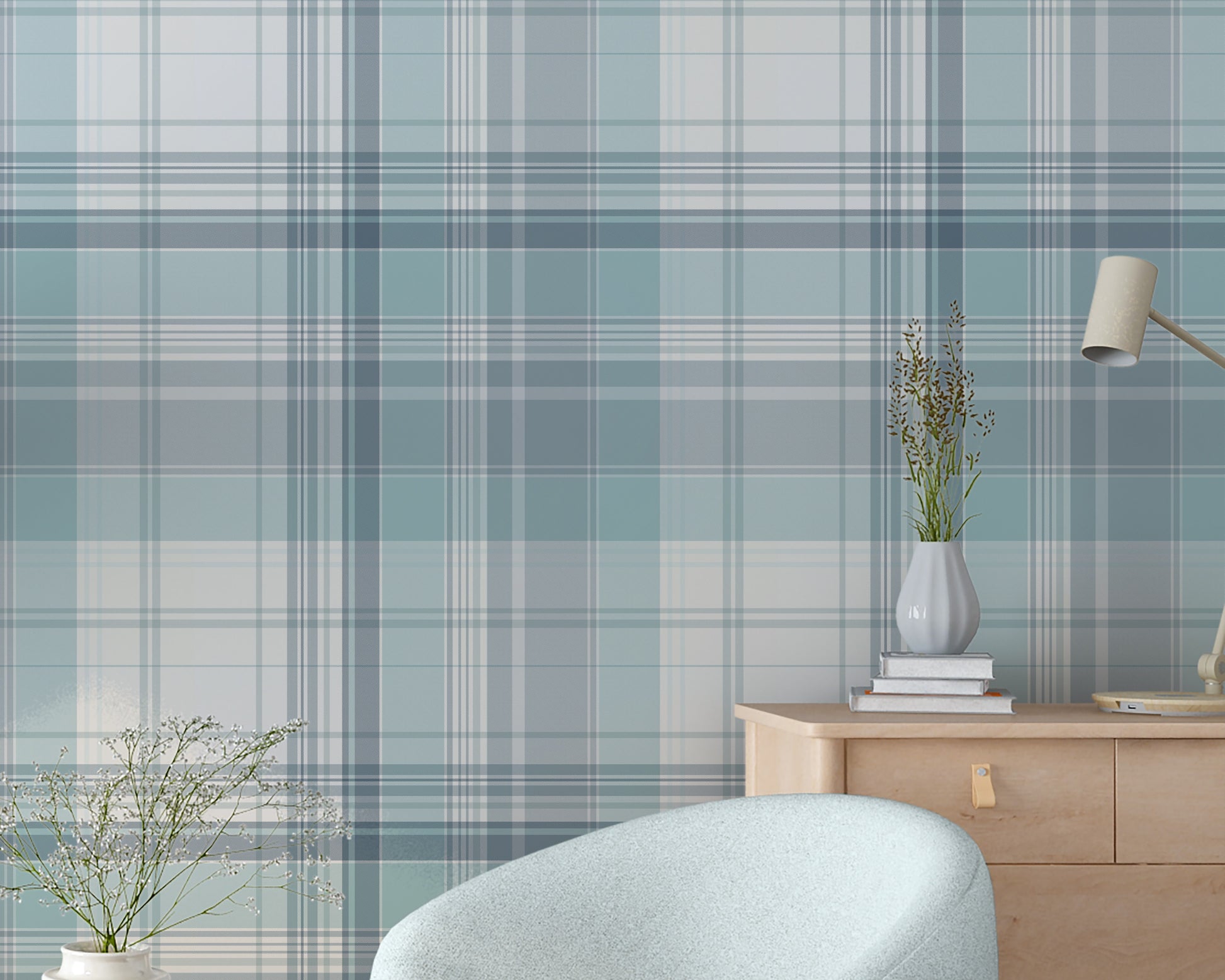 A bright room features a light blue and white plaid wallpaper pattern.
The wallpaper colors include shades of soft aqua, dusty blue, and white lines.
A rounded light blue armchair sits on the dark wood floor.
A small, round wooden side table holds a white vase with flowers.
A large green plant in a white pot stands on the left side.
A light wood dresser with a small desk lamp sits on the right.