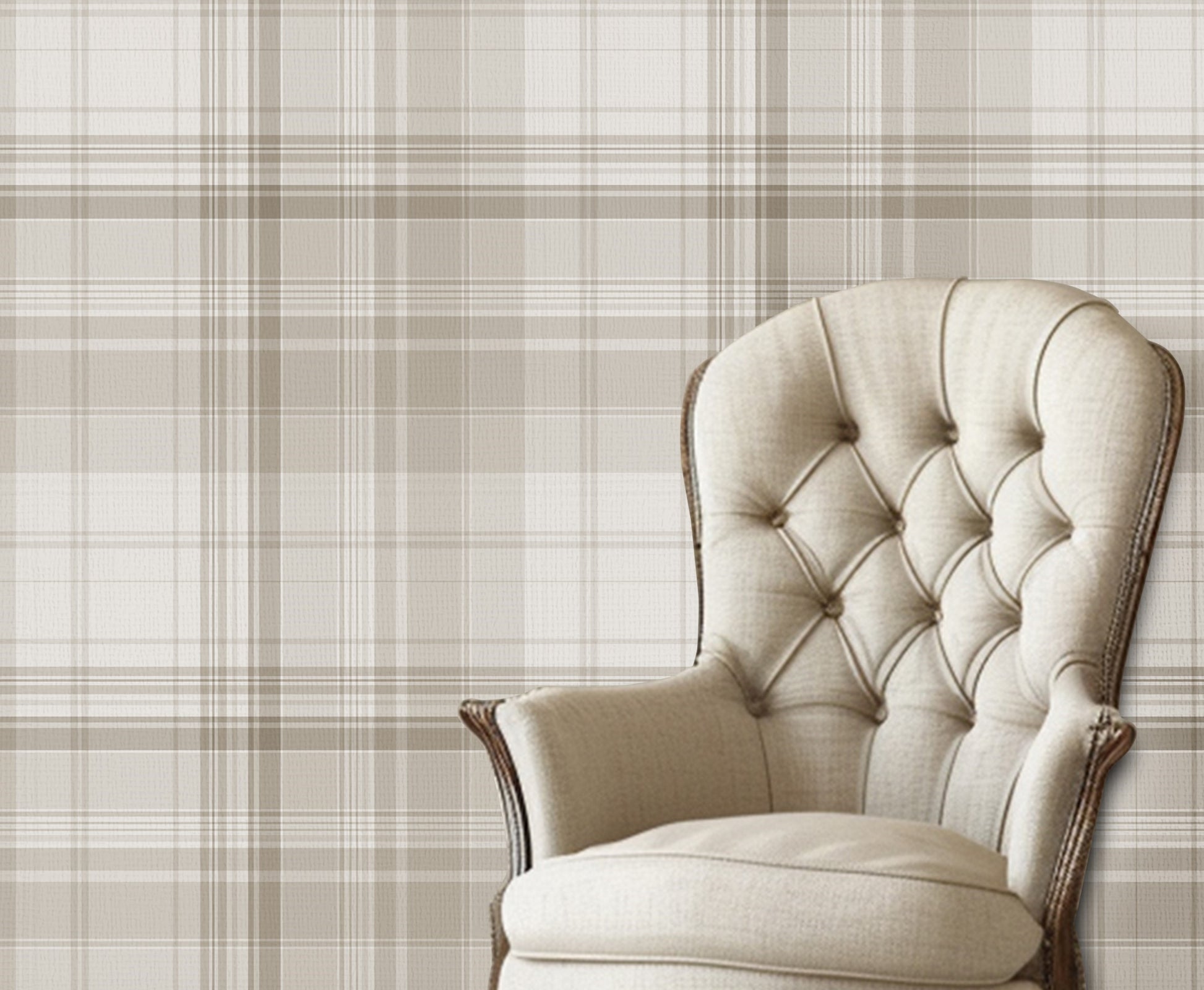 A classic interior scene featuring a beige tufted armchair with dark wooden legs placed against a neutral plaid wallpaper in soft taupe and cream tones. The room has white painted wood flooring and a calm, elegant aesthetic.