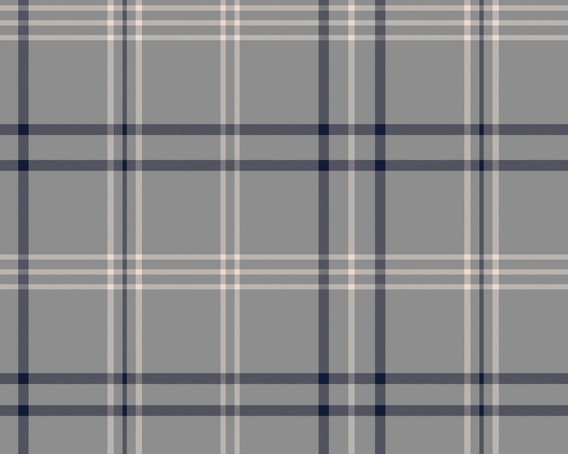 A minimalist home office workspace is set against a wall covered in grey, navy blue, and white plaid wallpaper.
In the center, a sleek black desk features a slim drawer built into its frame. Atop the desk sits a small table lamp with a grey base and a white cylindrical shade, a small square black photo frame, a gold pencil holder filled with pens, a wooden organizer, a stack of books, and a white soap dispenser bottle.A modern dark grey office chair with a curved backrest is pulled up to the desk, angled.