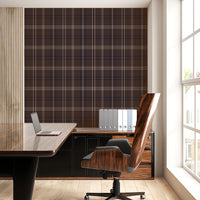 A bright, modern office features a desk setup with a brown plaid accent wall.
A glossy, dark wood desk holds an open laptop on its shiny surface.
Behind the desk, a matching storage cabinet holds a row of grey binders.
A high-backed office chair with a rich wood grain back faces the desk.
Light pours in from a large window on the right side of the room.
The room is complete with light-colored wood flooring and clean white walls.
