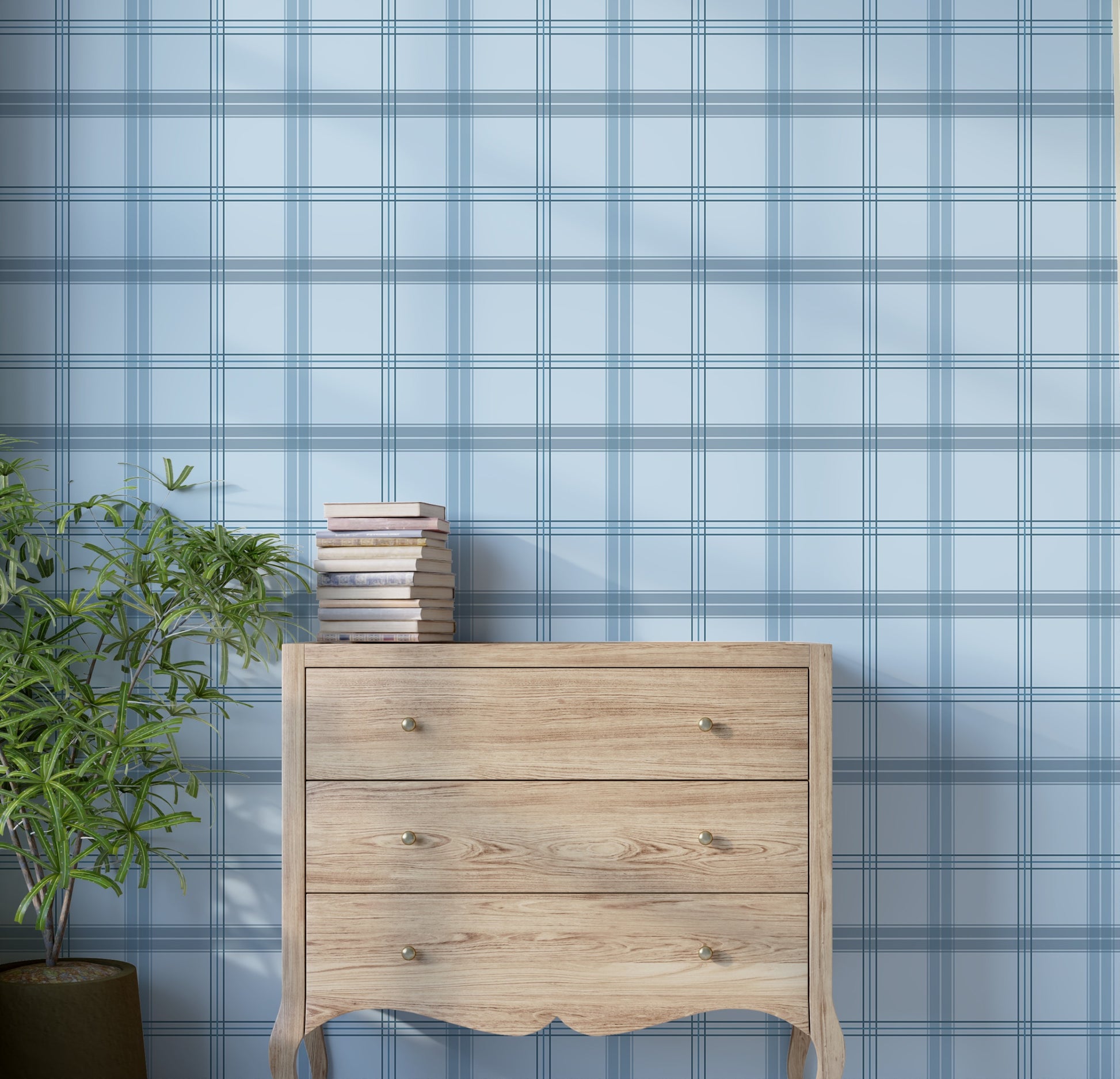 A serene interior space features a classic plaid wallpaper in light steel blue and cream tones.
The textured design displays a detailed grid pattern with intersecting blue, grey, and white lines.
In front, a rustic wooden chest of drawers stands against the wall holding a stack of books.
The charming interior setting is completed by a leafy green potted plant placed on the left side.