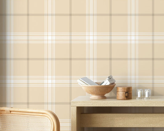 A stylish living area features a soft pale almond and off-white plaid wallpaper.
The detailed design shows intersecting light brown lines forming grids over a sandy base.
In front, a cream-colored wooden sideboard with woven rattan doors is centered nicely.
The serene setup is accented with a white desk lamp, pottery, and a leafy green plant.