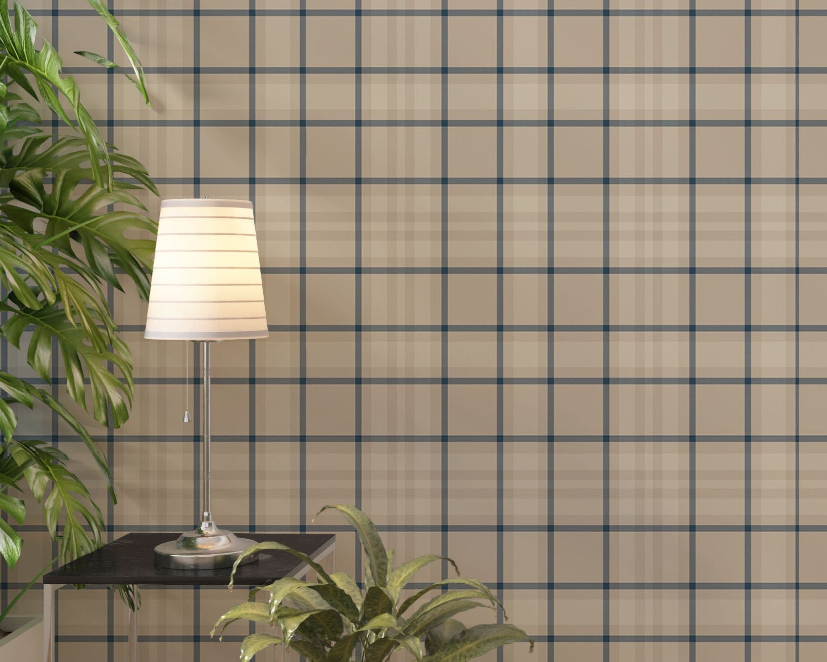 A modern living space featuring a warm soft caramel brown, beige, and cream plaid wallpaper accent wall. In the center, a light oak sideboard cabinet with wooden legs holds a small wooden tripod lamp, a geometric candle, and a round white ceramic vase with a single sprig of dried pampas grass. To the left, a woven basket sits on the light wood floor, filled with tall, fluffy pampas grass stalks and a draped blanket.