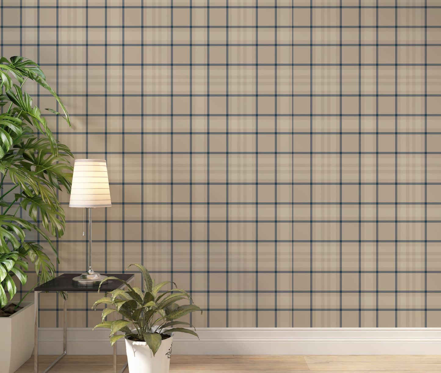 A modern living space featuring a warm soft caramel brown, beige, and cream plaid wallpaper accent wall. In the center, a light oak sideboard cabinet with wooden legs holds a small wooden tripod lamp, a geometric candle, and a round white ceramic vase with a single sprig of dried pampas grass. To the left, a woven basket sits on the light wood floor, filled with tall, fluffy pampas grass stalks and a draped blanket.
