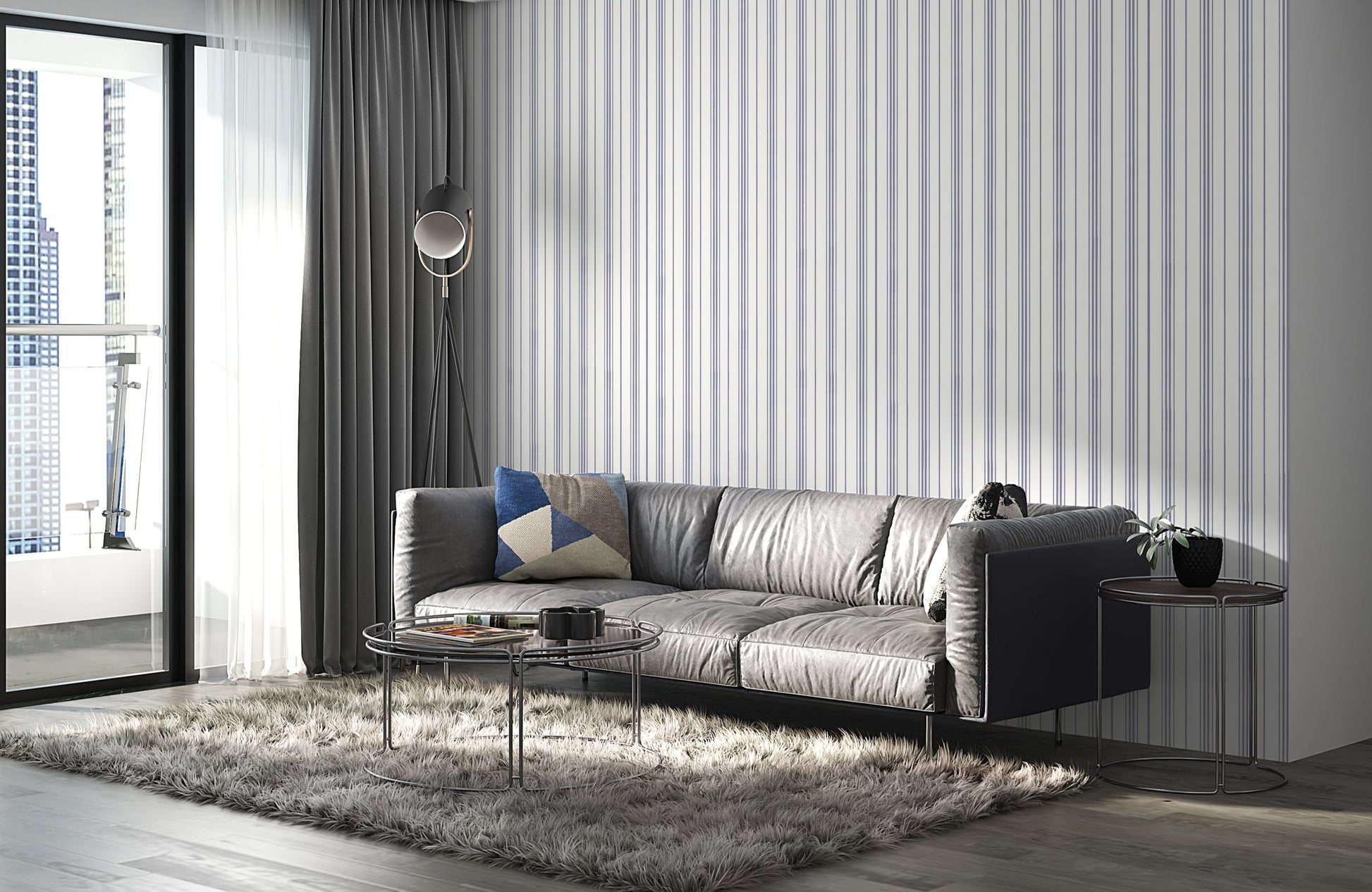 A gray leather sofa with a geometric-patterned throw pillow sits against a white wall decorated with thin vertical lavender-gray stripes. The minimalist interior features soft textures and a modern, neutral-toned design.