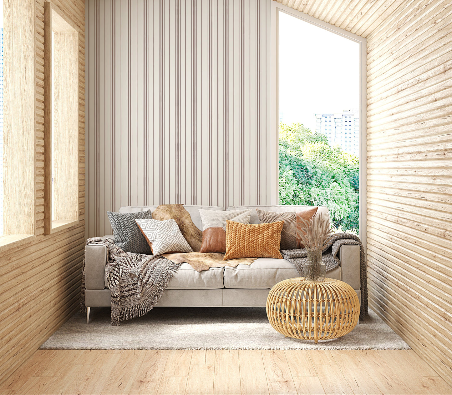 A close-up shot of a beige couch layered with an assortment of textured throw pillows, set against a backdrop of cream-colored wallpaper with vertical brown stripes. The pillows feature various designs, including a grey chunky knit, a white and grey geometric diamond pattern, a smooth brown leather accents, and a bright mustard yellow knit. A fluffy brown faux-fur blanket is also draped over the back of the sofa, creating a warm, cozy interior aesthetic.