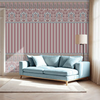 Rajmahal Floral Stripe Wallpaper in dusty rose pink and blue tones, shown behind a modern light blue sofa with a floor lamp and white rug, as seen.