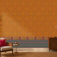 Royal Garden Heritage Wallpaper in Burnt Saffron with intricate peacock motifs, floral accents, and traditional Indian architectural border design, styled in a warm living room with wooden furniture, brass décor, and natural textures.