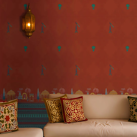 Cozy seating area featuring a warm terracotta-orange wallpaper with small repeating traditional motifs and an illustrated architectural border along the base. The space includes cream upholstered bench seating with ornate geometric cushions in red, gold, and blue tones, illuminated by a brass Moroccan-style wall lantern. Rich colors, decorative textiles, and ambient lighting create an elegant, Indian-inspired lounge setting.

