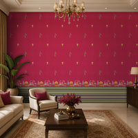 Elegant living room featuring a vibrant fuchsia accent wall adorned with small repeating traditional motifs and an ornate architectural border along the base. The space includes cream upholstered seating with magenta accent cushions, a dark wood coffee table with a floral arrangement, a patterned area rug, and a brass chandelier overhead. Large arched windows and warm natural light complement the rich colors and create a sophisticated, Indian-inspired interior.