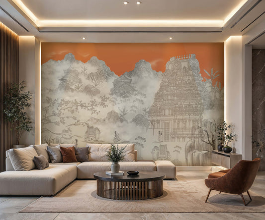 Contemporary living room featuring a large mural wallpaper in soft gray tones depicting misty mountains, traditional architecture, and an ornate South Indian temple against a warm sunset-orange background. The space includes a cream sectional sofa with neutral and rust-colored cushions, a round dark wood coffee table, and a cognac accent chair. Recessed lighting, natural textures, and minimalist furnishings create a serene, sophisticated atmosphere that blends modern design with Asian-inspired artistic elem