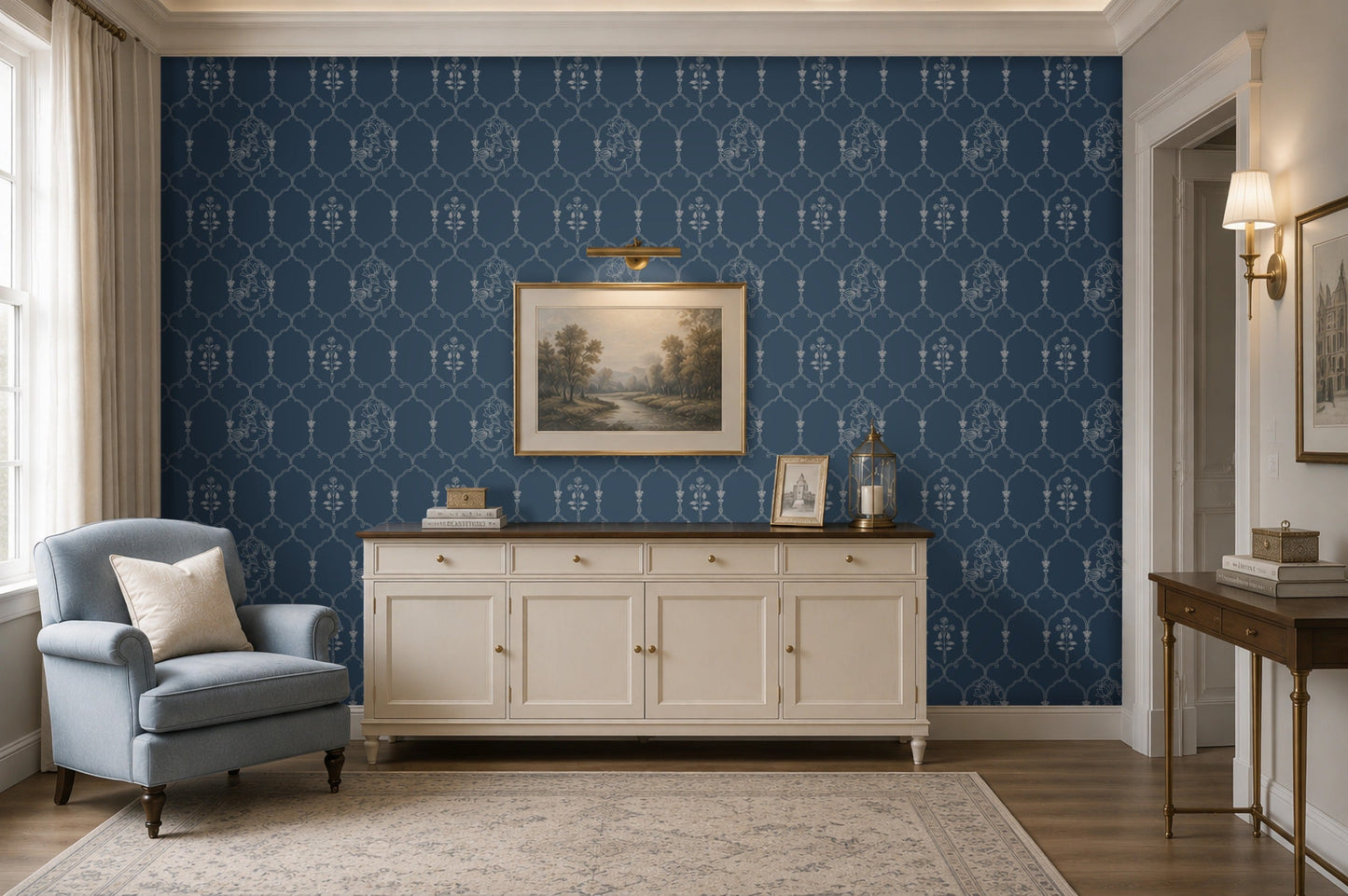 Deep heritage blue wallpaper featuring an intricate Pichwai-inspired trellis pattern with delicate floral motifs and traditional cow illustrations, styled behind a cream sideboard with framed landscape art and brass décor accents in an elegant living room.
