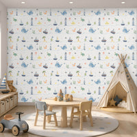 Little Mariners kids wallpaper in a soft misty grey color way featuring playful whales, sailboats, lighthouses, turtles, submarines, and sea creatures, styled in a modern playroom with a teepee tent, wooden toys, and Scandinavian-inspired décor.