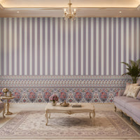 Elegant living room featuring pastel lavender striped wallpaper with an ornate floral border inspired by Persian and Mughal motifs. Styled with classic lilac upholstered furniture, gold accents, and luxurious décor, creating a timeless heritage-inspired interior.