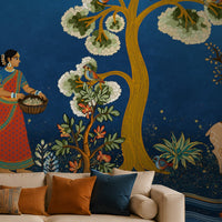 Traditional Gond Art wallpaper in royal blue featuring hand-painted Indian folk art with trees, birds, wildlife, and village life, displayed as a luxury living room feature wall.