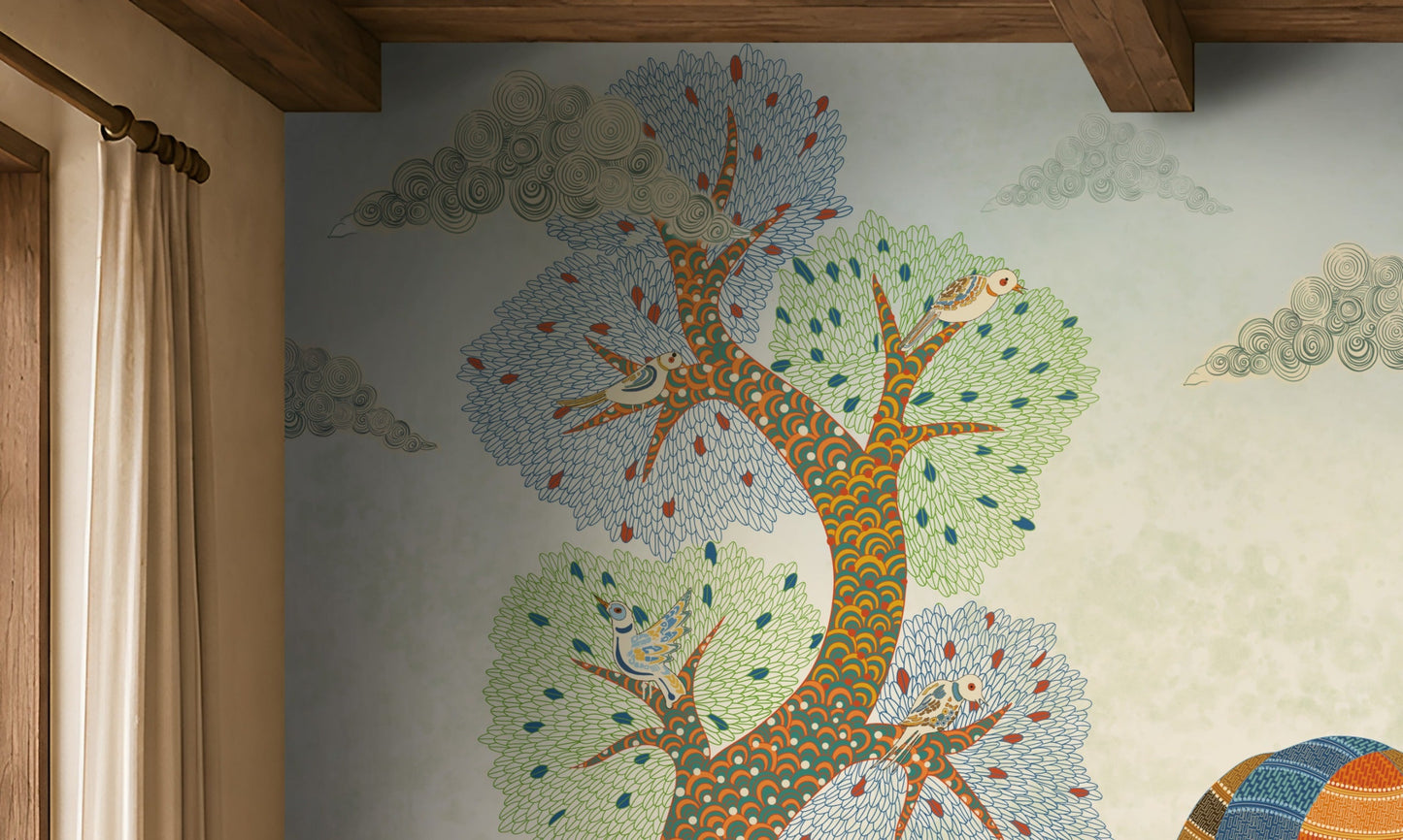 Traditional Gond Art wallpaper mural featuring hand-painted Indian folk art with colorful trees, birds, deer, cattle, and a village woman on a soft ivory background, showcased in a warm contemporary living room with natural wood furniture and earthy décor.
