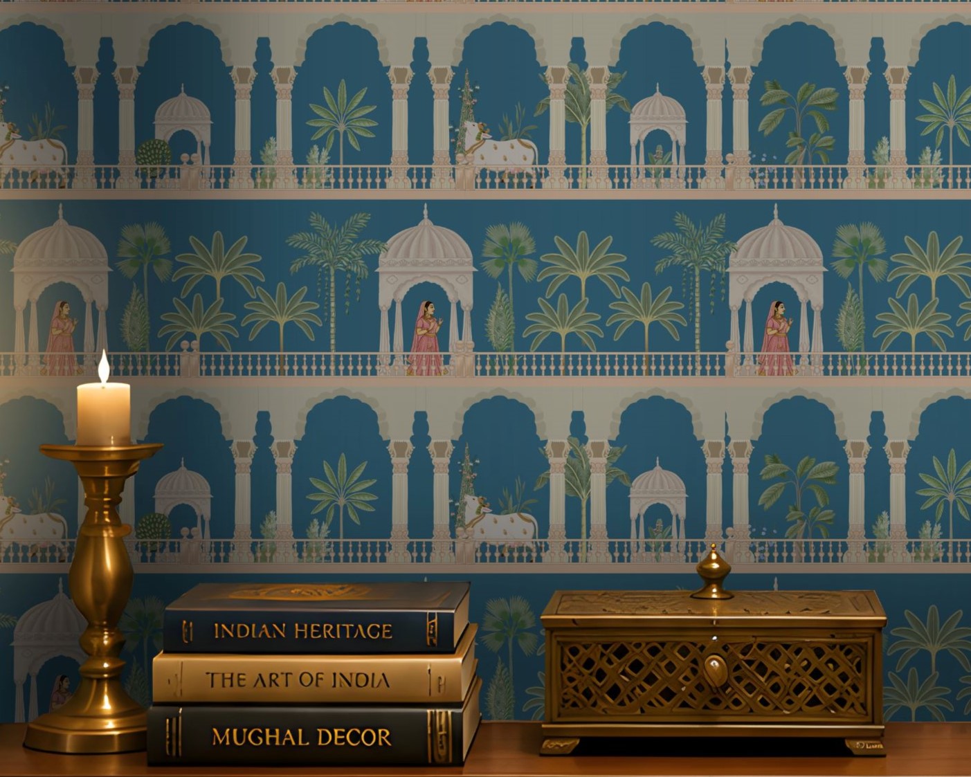 A recessed entryway display features a striking blue-and-white wallpaper with repeating Mughal-inspired arches, domed pavilions, palm trees, elephants, and figures in traditional attire. A dark wood floating console with lattice-front drawers sits below, styled with brass décor, stacked books, a candle, and a decorative animal figurine. Warm recessed and under-cabinet lighting, paired with ornate brass wall sconces, highlights the niche, while a large brass bowl rests on the floor beneath