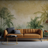 An architectural perspective of a high-end lounge area featuring the Tropical Palm Mural as a full-scale feature wall behind a deep mustard-toned sofa. The mural’s warm, earthy palette creates a sophisticated, sun-drenched atmosphere that pairs elegantly with gold-finished lighting and contemporary neutral upholstery.