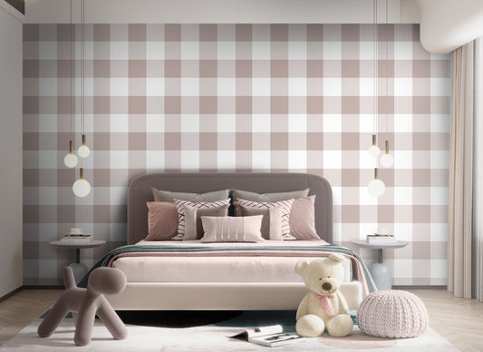 A cozy bedroom features a soft pastel checks wallpaper in a pastel silver theme.
The delicate design displays a clean grid pattern with intersecting muted pink-grey and white blocks.
In front, a neatly made bed with dusty pink pillows and blankets is centered in the space.
The sweet, modern interior setup is nicely completed by a plush teddy bear sitting on the floor.