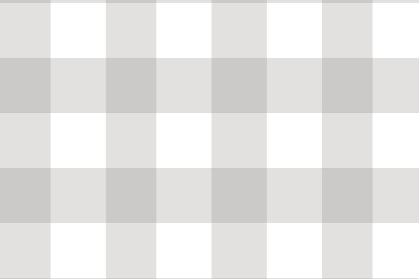 A serene nursery room features a soft gingham check wallpaper in cloud grey.
The design displays a large grid pattern with alternating light grey and white blocks.
In front, a white wooden baby crib filled with plush star and animal toys is centered.
The calm and peaceful interior layout is nicely completed by a light grey rug on the floor.