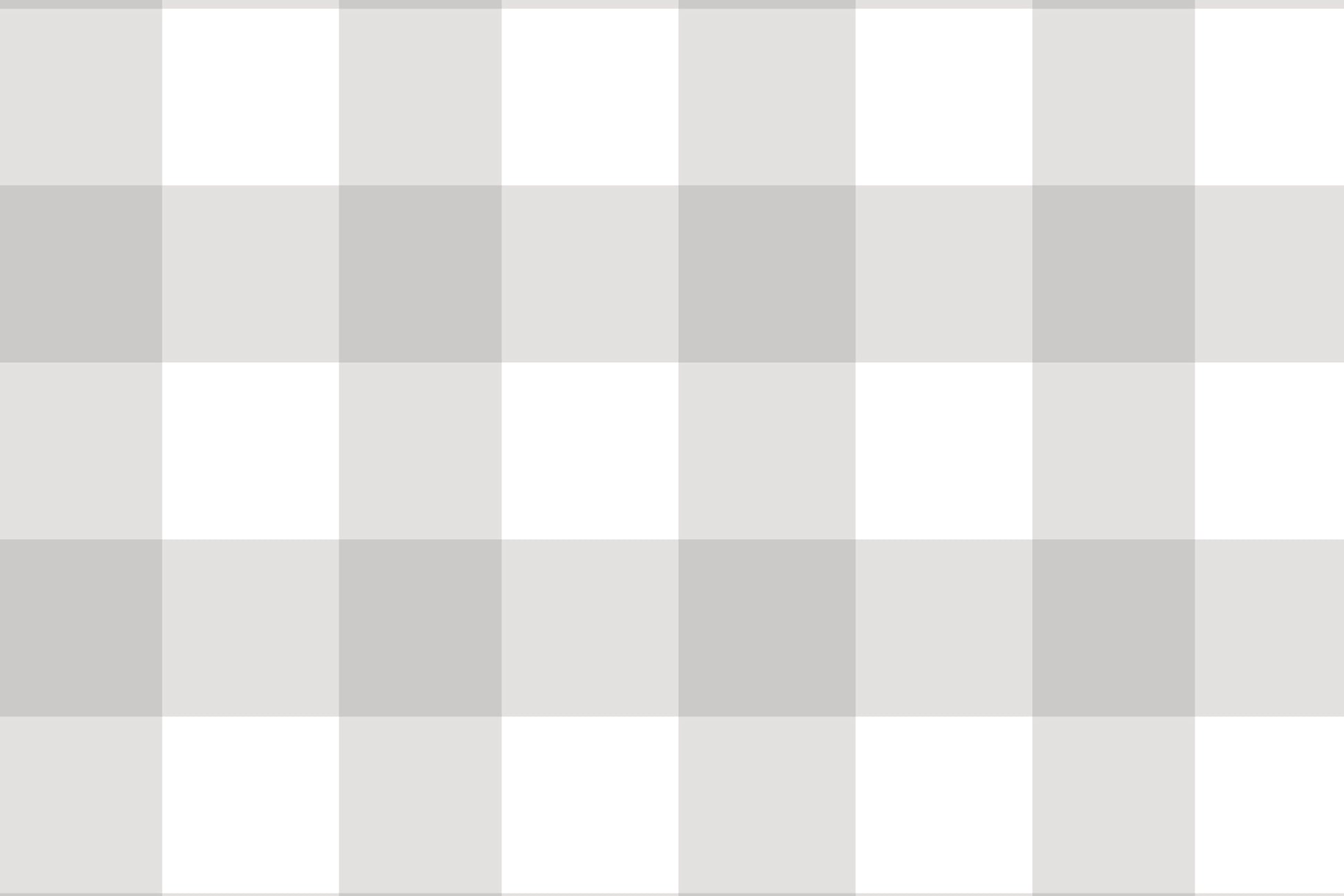 A serene nursery room features a soft gingham check wallpaper in cloud grey.
The design displays a large grid pattern with alternating light grey and white blocks.
In front, a white wooden baby crib filled with plush star and animal toys is centered.
The calm and peaceful interior layout is nicely completed by a light grey rug on the floor.