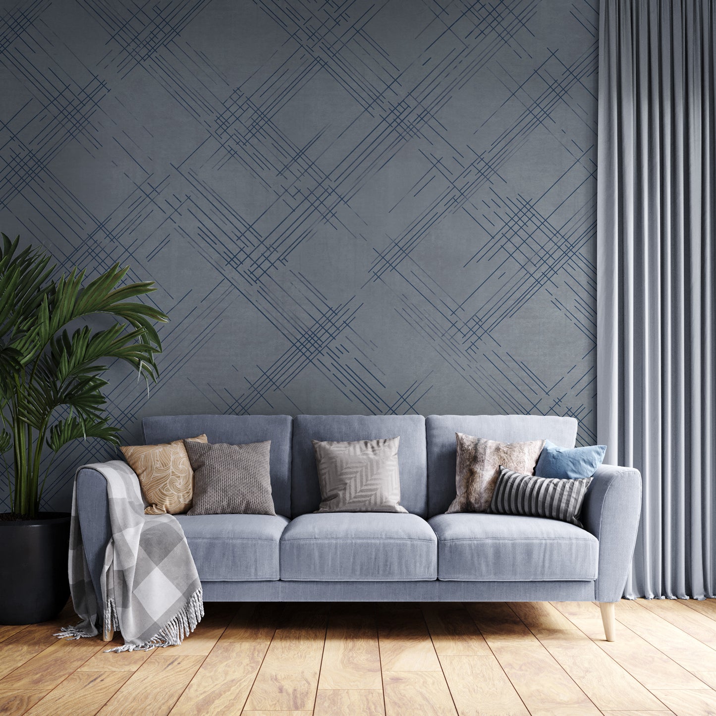A modern interior features a textured crosshatch wallpaper in a steel grey theme.
The fabric-look pattern displays intersecting dark blue-grey sketch lines over a medium grey background.
In front, a comfortable light beige armchair with a blanket sits on a round woven rug.
The simple, contemporary layout is completed by a small wooden side table holding flowers.