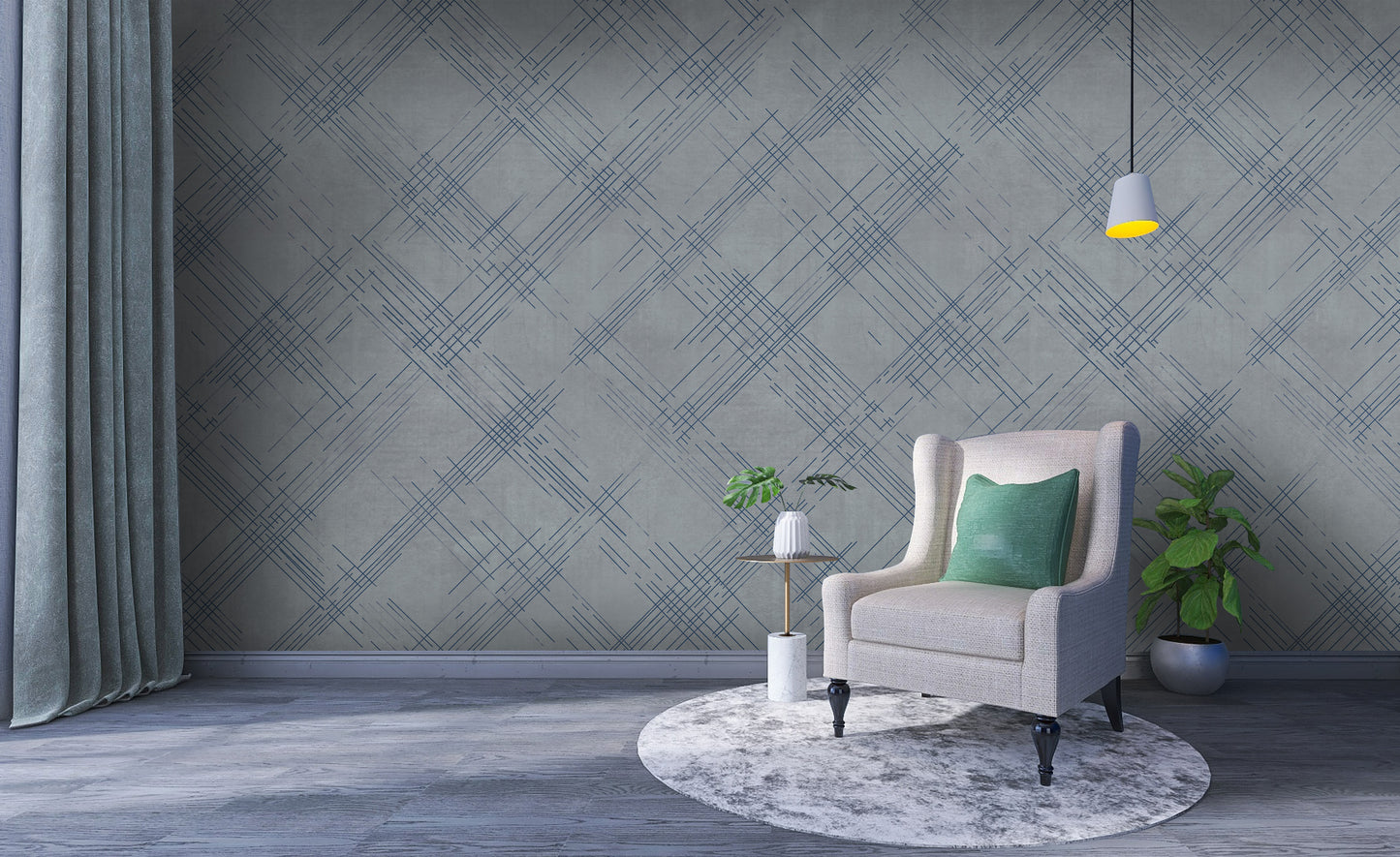 A modern interior features a textured crosshatch wallpaper in a steel grey theme.
The fabric-look pattern displays intersecting dark blue-grey sketch lines over a medium grey background.
In front, a comfortable light beige armchair with a blanket sits on a round woven rug.
The simple, contemporary layout is completed by a small wooden side table holding flowers.